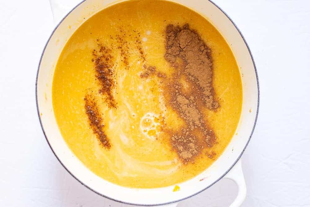 butternut squash soup with spices in a white pot