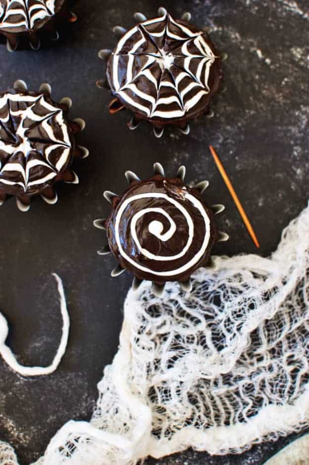 These Spiderweb Cupcakes look delightfully spooky and taste sinfully delicious! These cupcakes are perfect to make with your little ones for a party or just for fun! || The Butter Half #halloweentreats #spookytreats #cupcakes #thebutterhalf