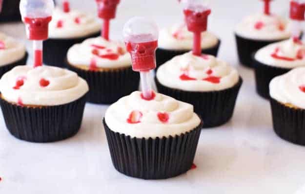 Vampire Bite Cupcakes with Edible Blood | easy halloween recipes, halloween dessert recipes, halloween treat recipes, halloween cupcake recipes, fun halloween recipes, vampire recipe ideas, spooky halloween treats, kid-friendly halloween treats, homemade halloween recipes || The Butter Half via @thebutterhalf
