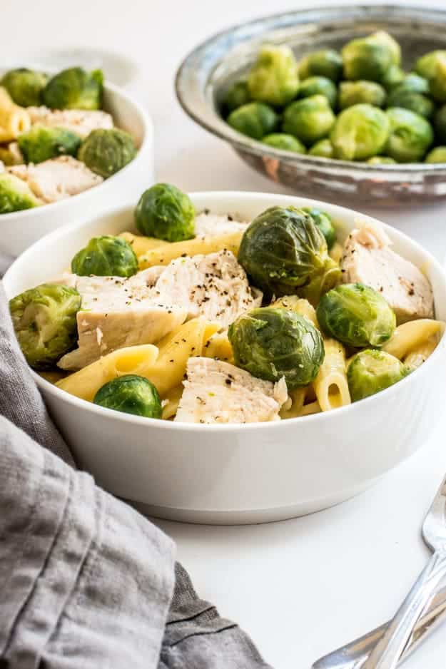 Bowl of chicken pasta and green vegetables 