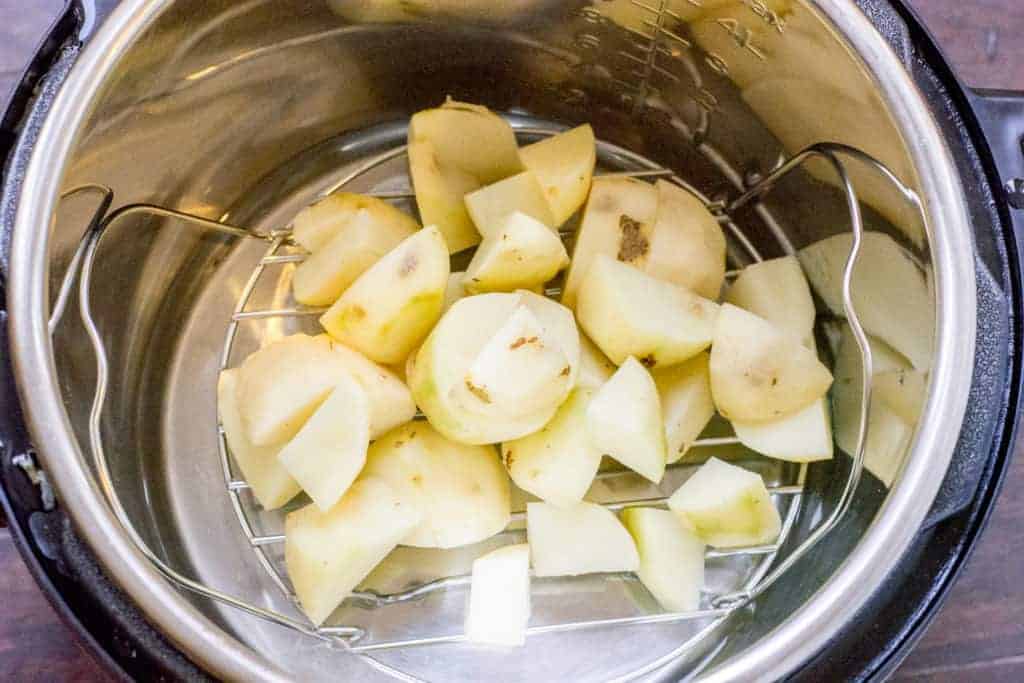 Cut potatoes in Instant Pot bowl on steamer rack
