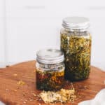 Herb infused oils in two mason jars