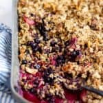angled shot of finished berry crisp in metal baking pan