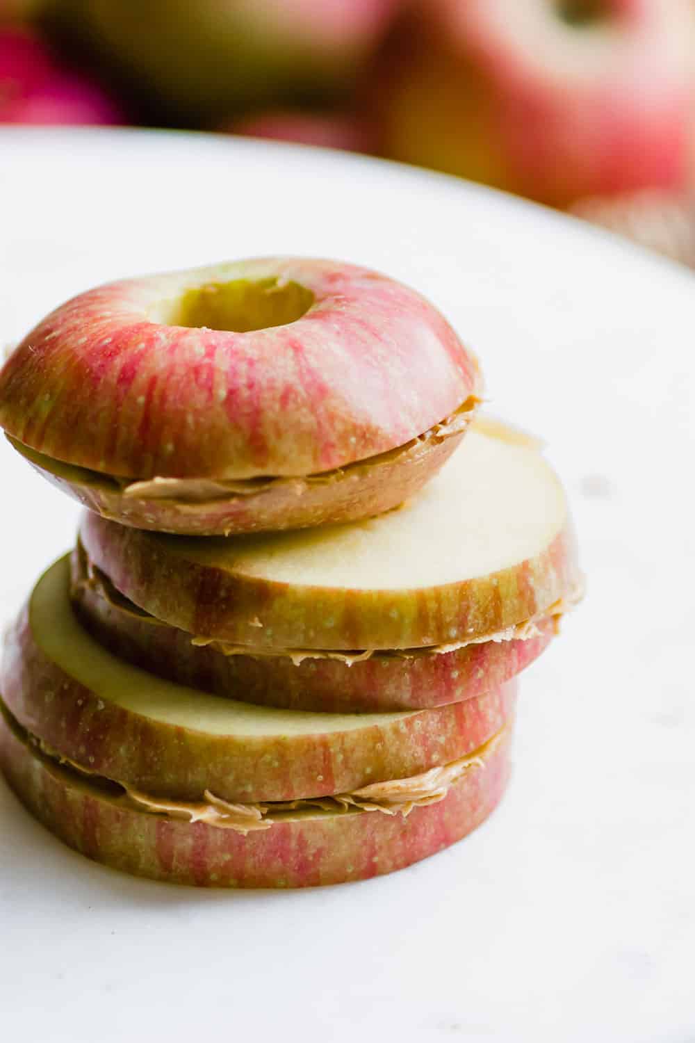 stack of three apple and peanut butter sandwiches