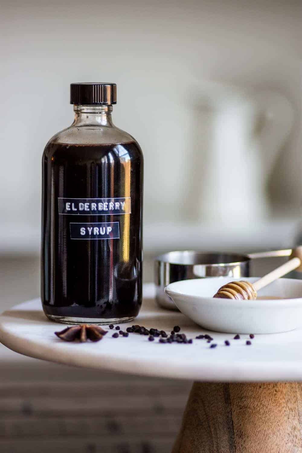 An easy Elderberry Syrup Recipe made with dried elderberries, echinacea, herbs, and honey. Great for colds and supporting the immune system when used medicinally, or used as a syrup for drinks or mixed in with maple syrup as a topping for food. || The Butter Half #elderberry #elderberrysyrup #naturalremedies #herbalremedies #holisticremedies #thebutterhalf