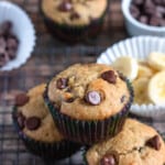 3 easy gluten-free banana muffins stacked in a triangular position with a dark colored background