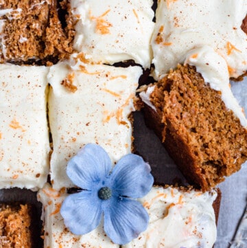 Gluten Free Carrot Cake sliced with lavender flowers topping 3 slices