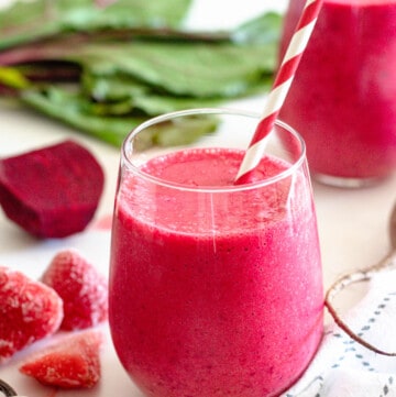 small glass filled with detoxifying beet smoothie recipe with a light colored background