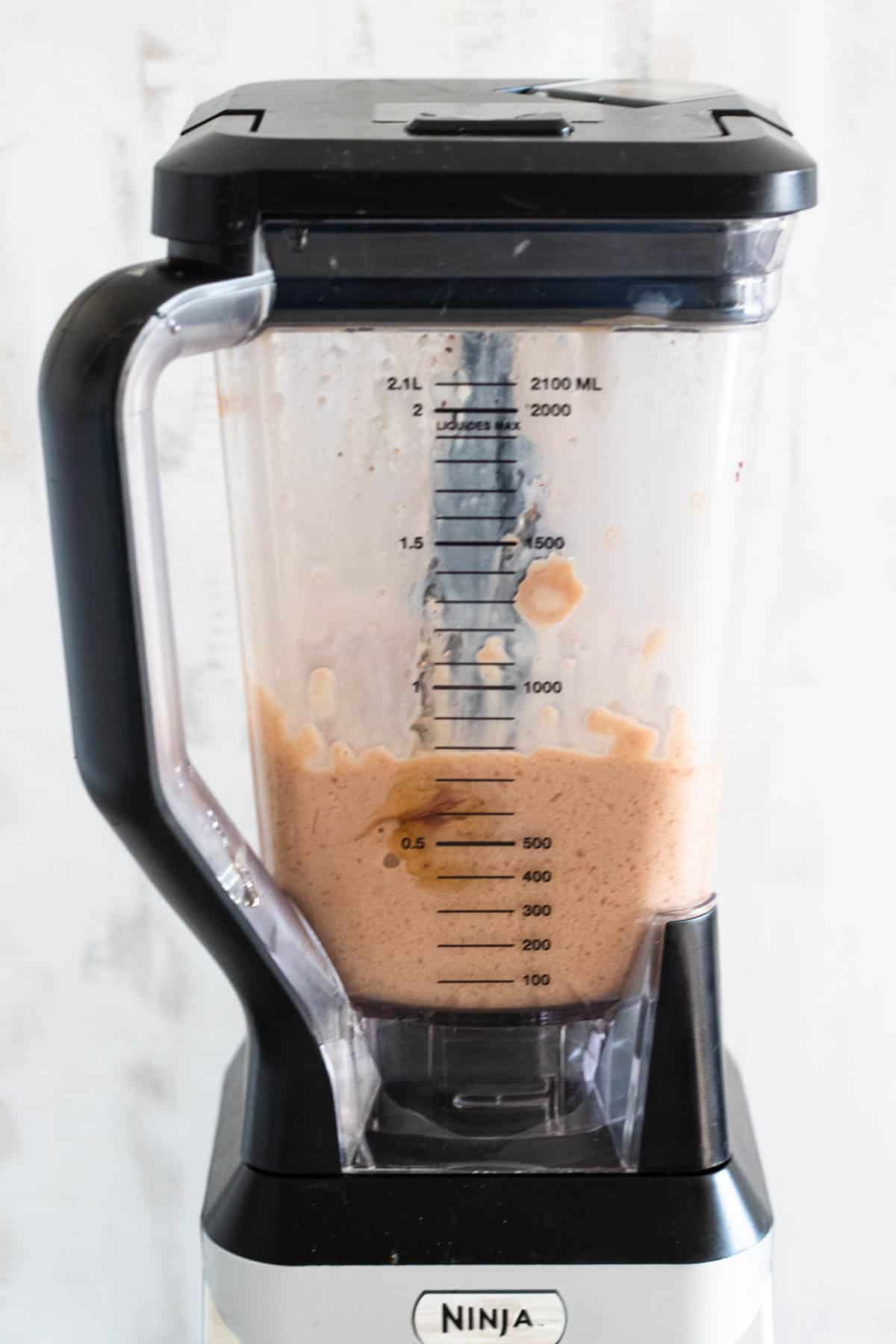 blender with blended coffee smoothie ingredients