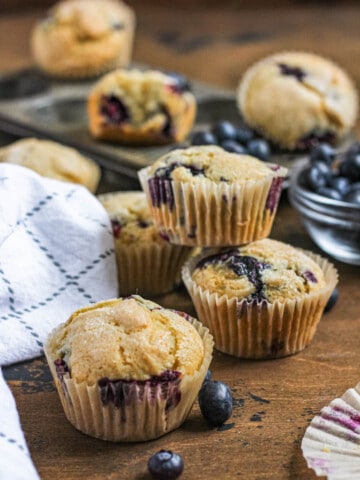 easy gluten free blueberry muffins with a dark colored background