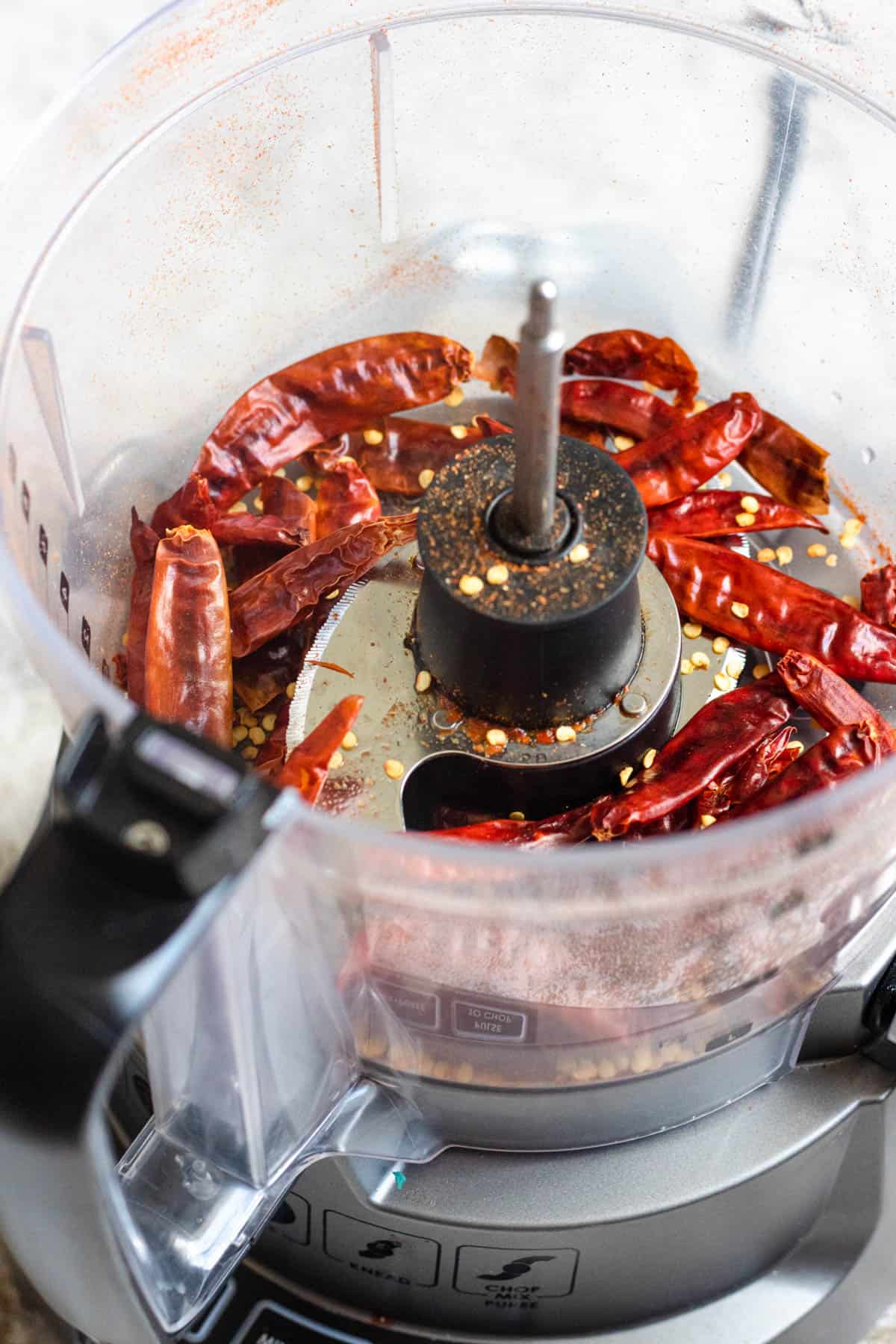 food processor filled with whole dried peppers