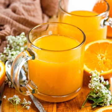 two glasses filled with homemade orange juice recipe