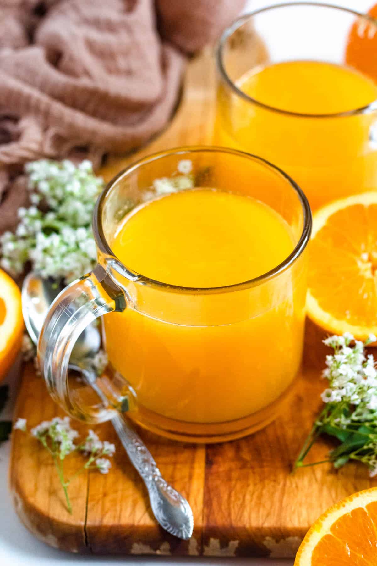 two glasses filled with homemade orange juice 