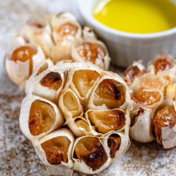 roasted garlic bulbs with a light colored background