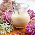 sweetened condensed milk in a glass with a light colored background