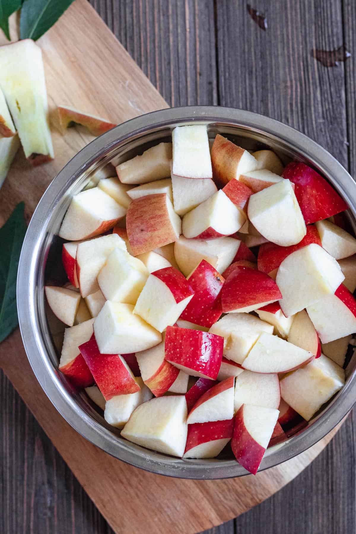 cubed apples in a medium sized bowl with a darker colored background