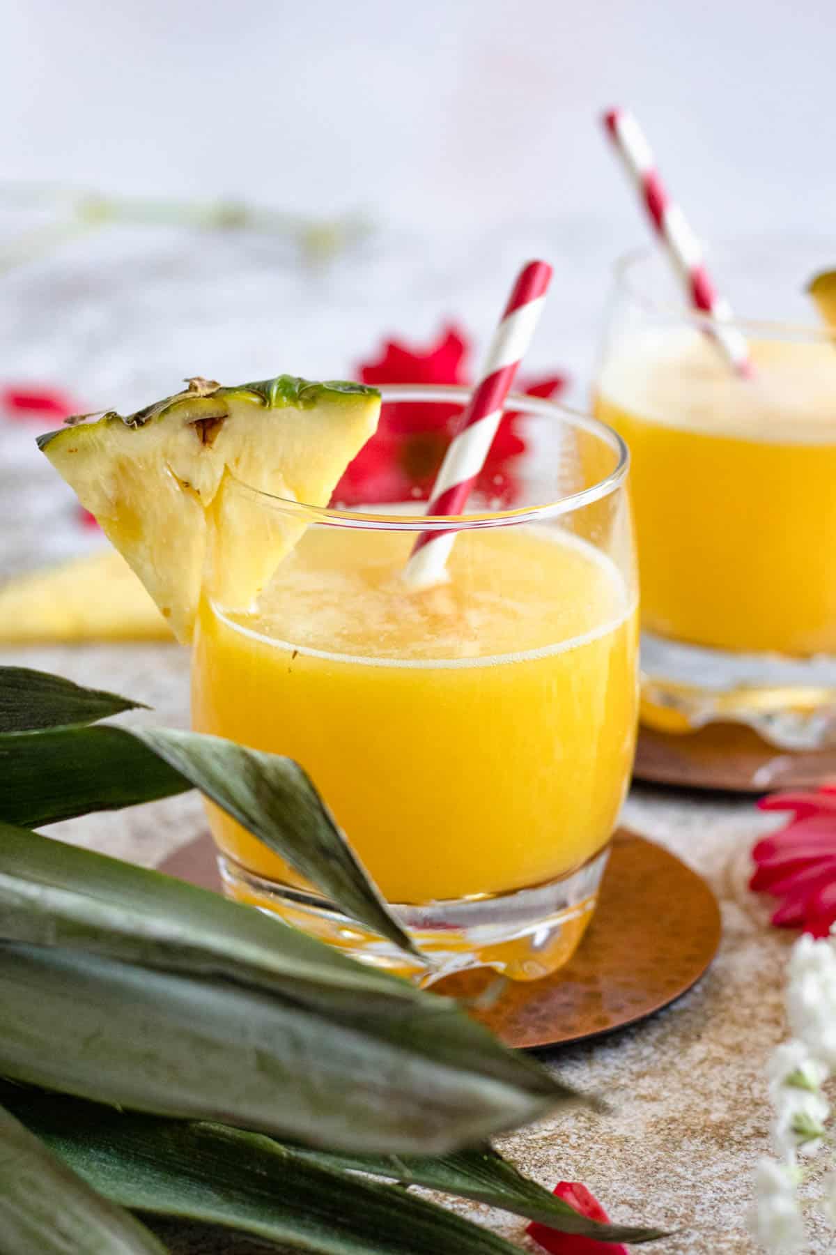 homemade pineapple juice in two glasses with a light colored background