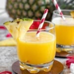 glass filled with homemade pineapple juice with a light colored background