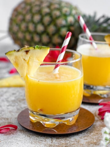 glass filled with homemade pineapple juice with a light colored background
