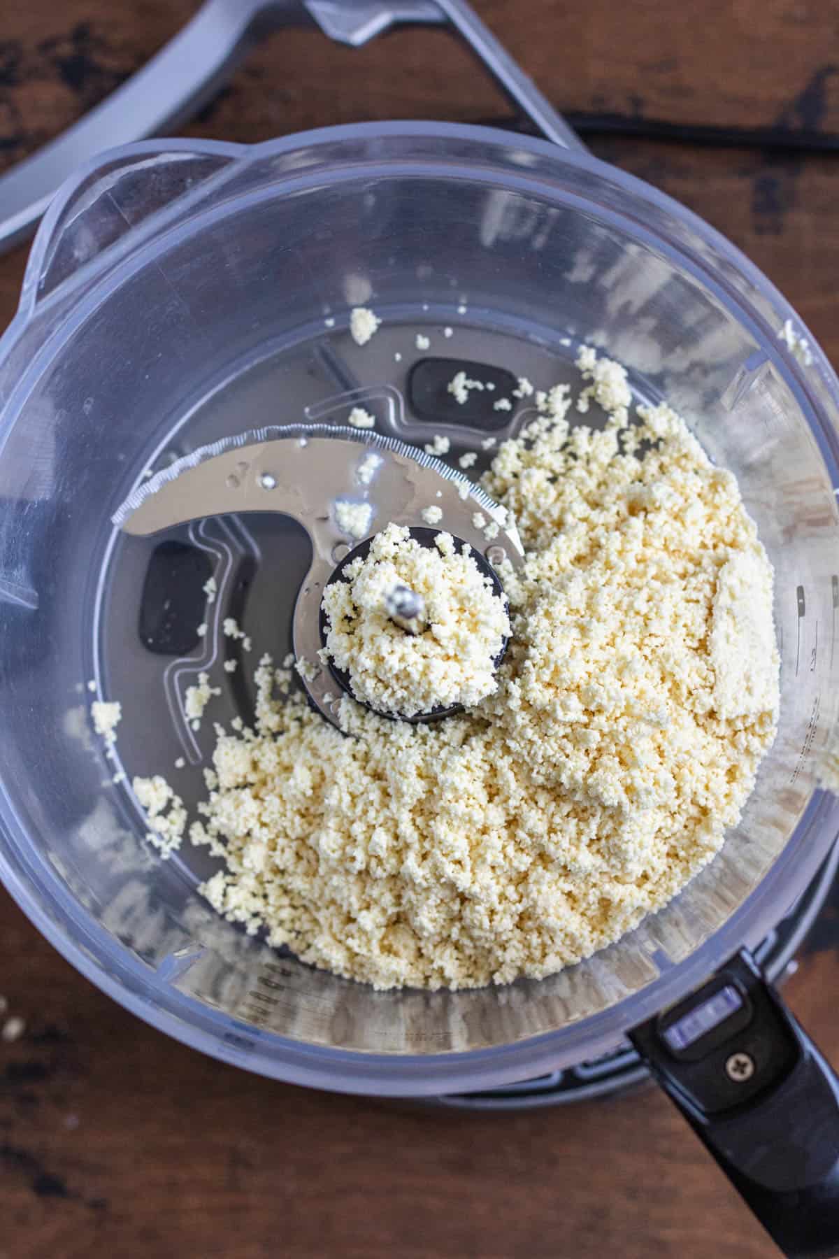 crumbly white chocolate mixture in a food processor not yet processed