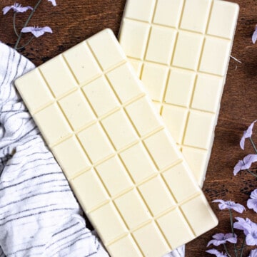 two white chocolate bars with a dark colored background
