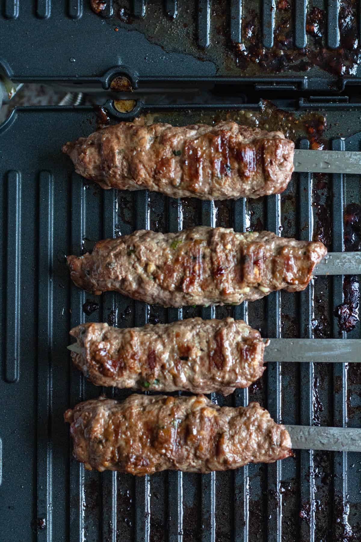Kofta meat grilled on skewers on grill