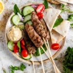 Kofta on skewers with a light colored background