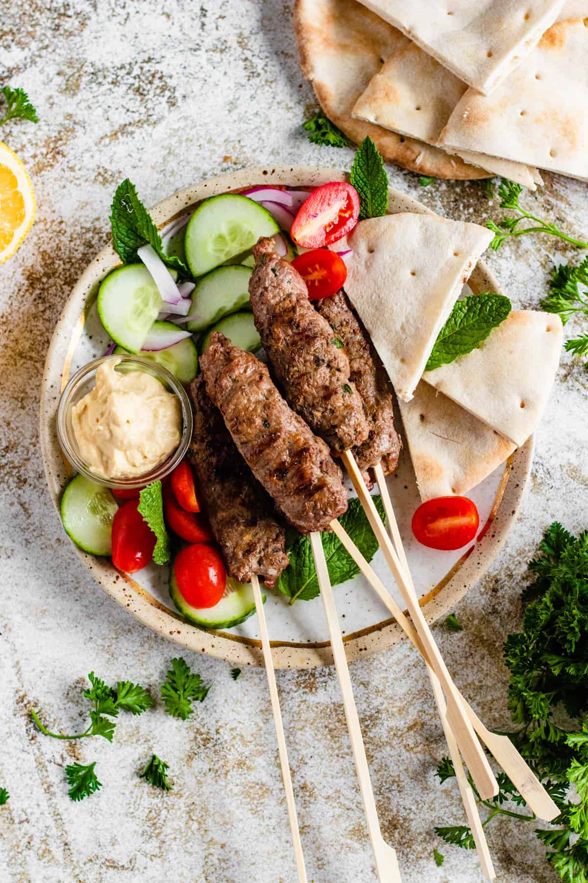 Kofta on skewers with a light colored background