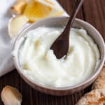 homemade garlic sauce in a small bowl with a dark colored background