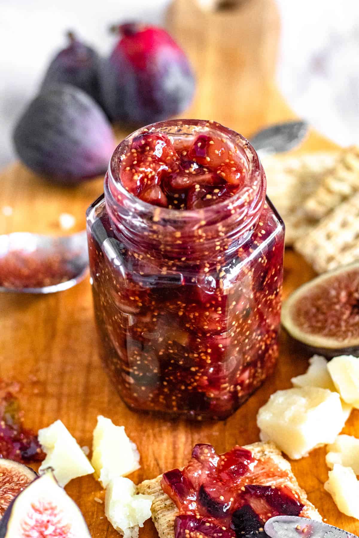 homemade fig jam in a small glass jar with a light colored background