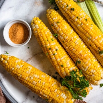 oven roasted corn on the cob with a light colored background