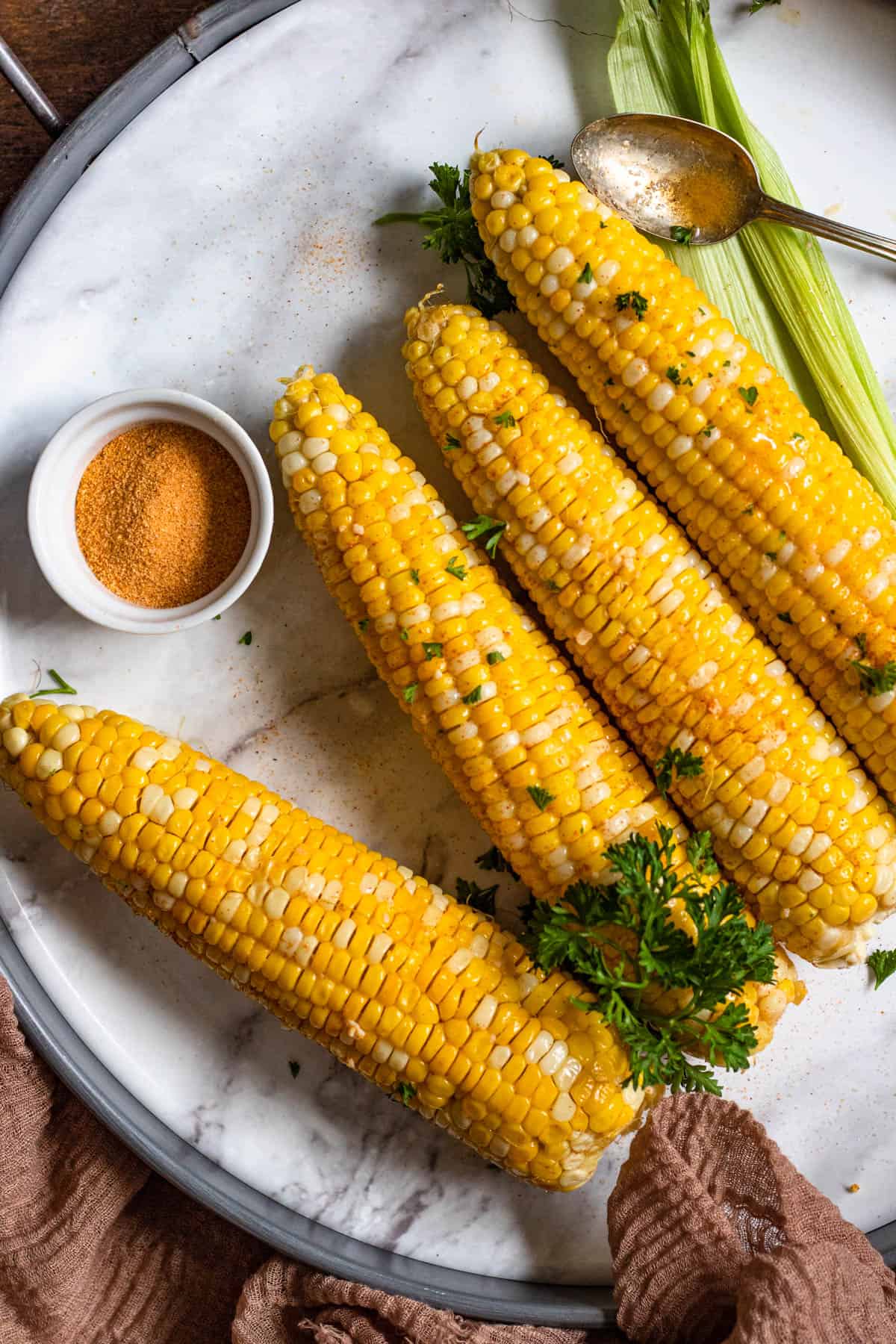 oven roasted corn on the cob with a light colored background