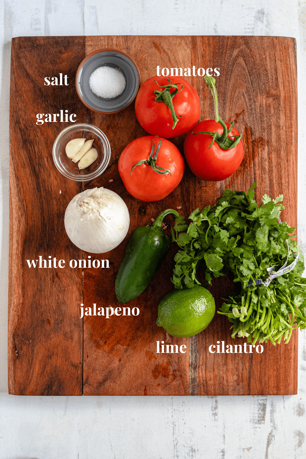salsa roja ingredients on a wooden cutting board 