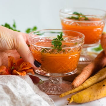 carrot juice in decorative glasses with a light colored background
