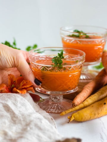 carrot juice in decorative glasses with a light colored background