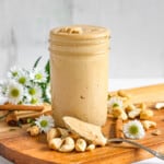 cashew butter in a glass jar with a light colored background
