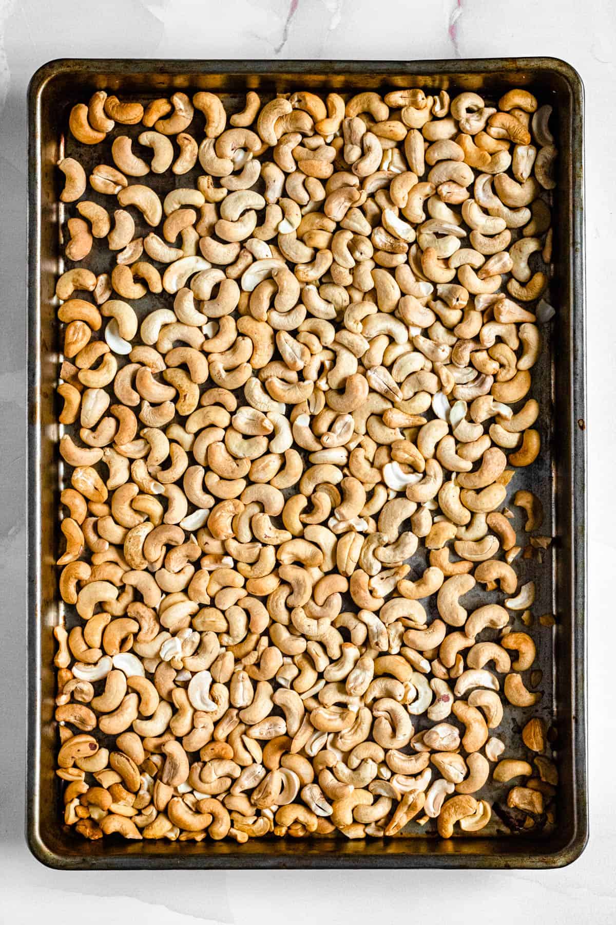 toasted cashews on a baking sheet