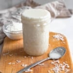 coconut butter in a small glass jar with a light colored background