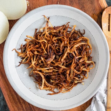 crispy fried onions on a round white plate