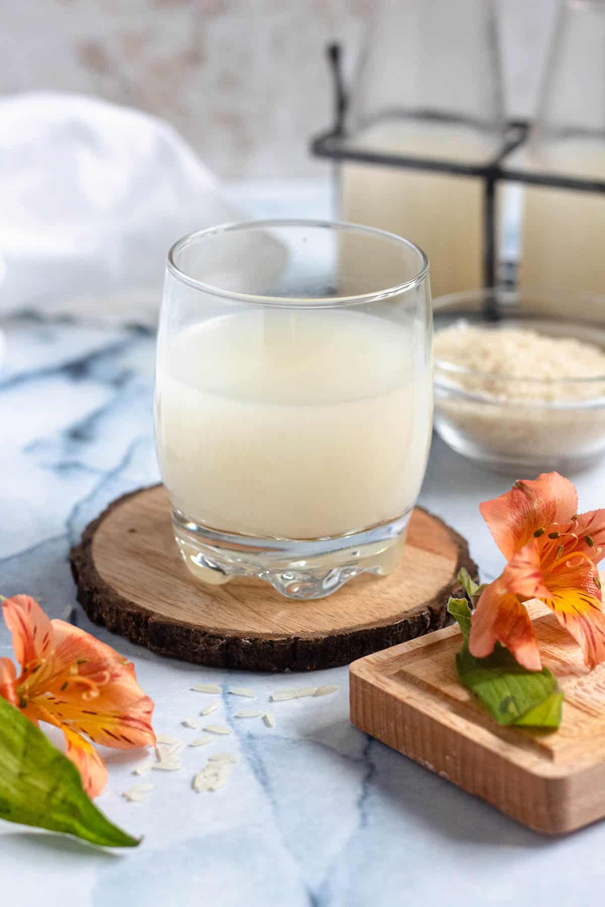 homemade rice milk in a glass with a light colored background