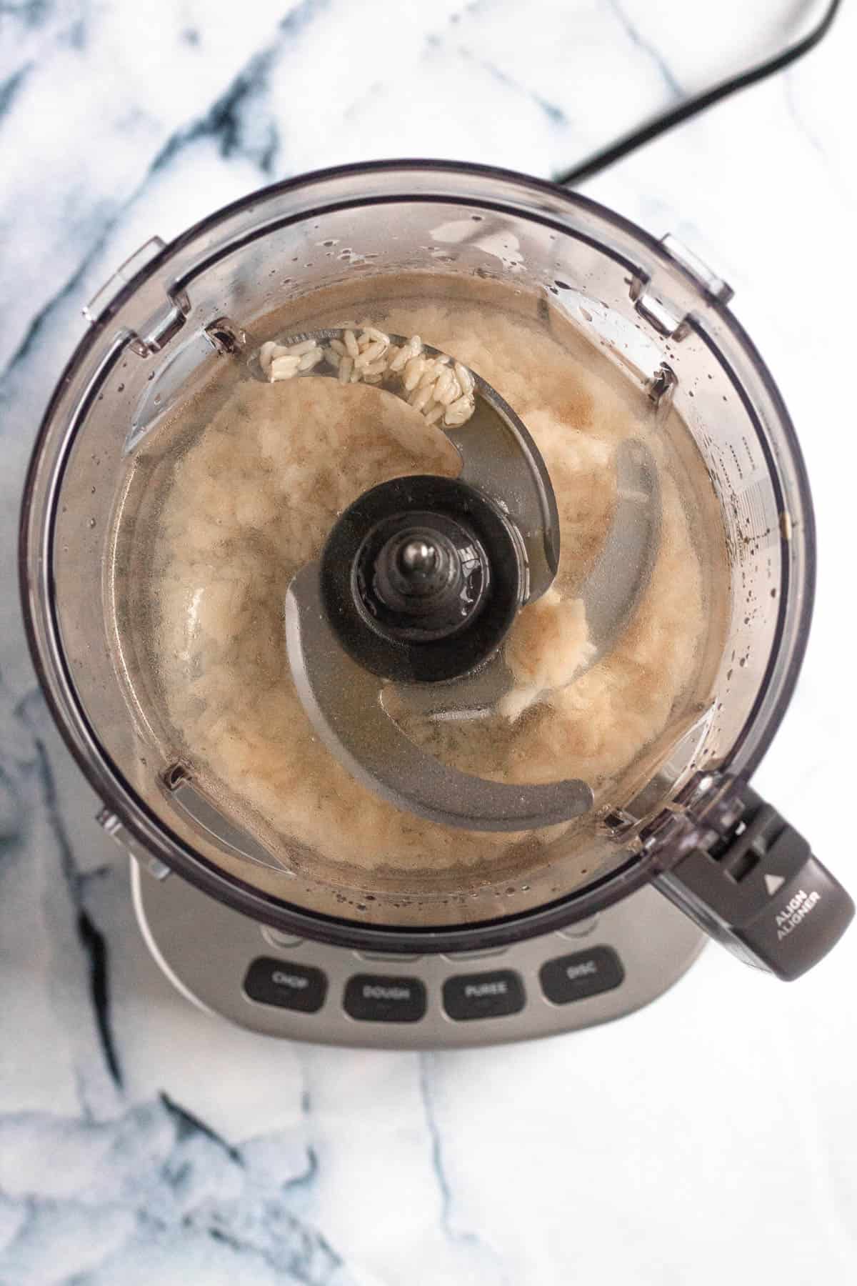 cooked rice, water and maple syrup in a food processor
