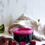 beetroot juice in a glass with a light colored background