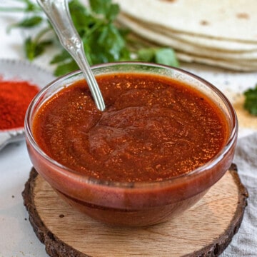 homemade chili sauce in a small glass dish with a light colored background
