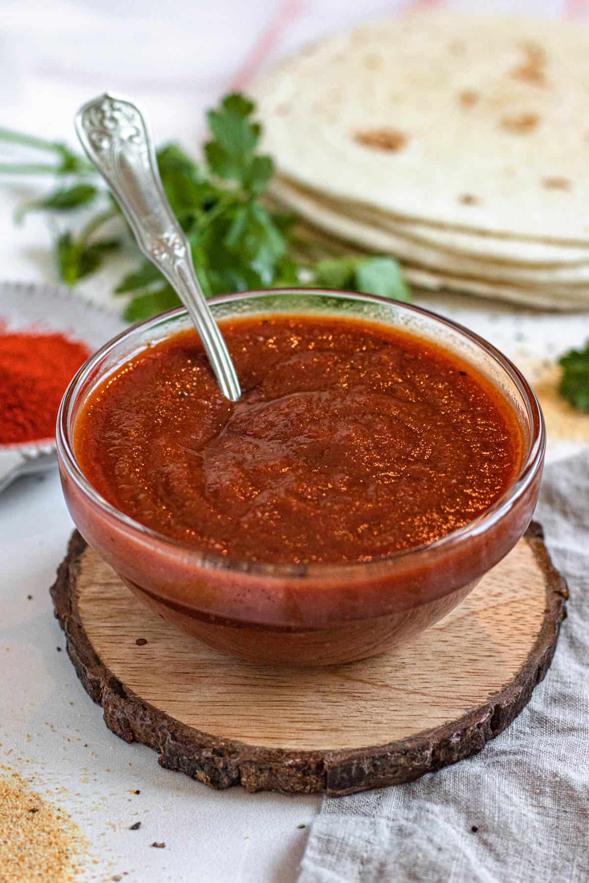 homemade chili sauce in a small glass dish with a light colored background