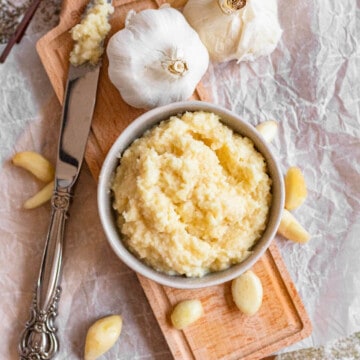 homemade garlic paste in a bowl with a medium colored background