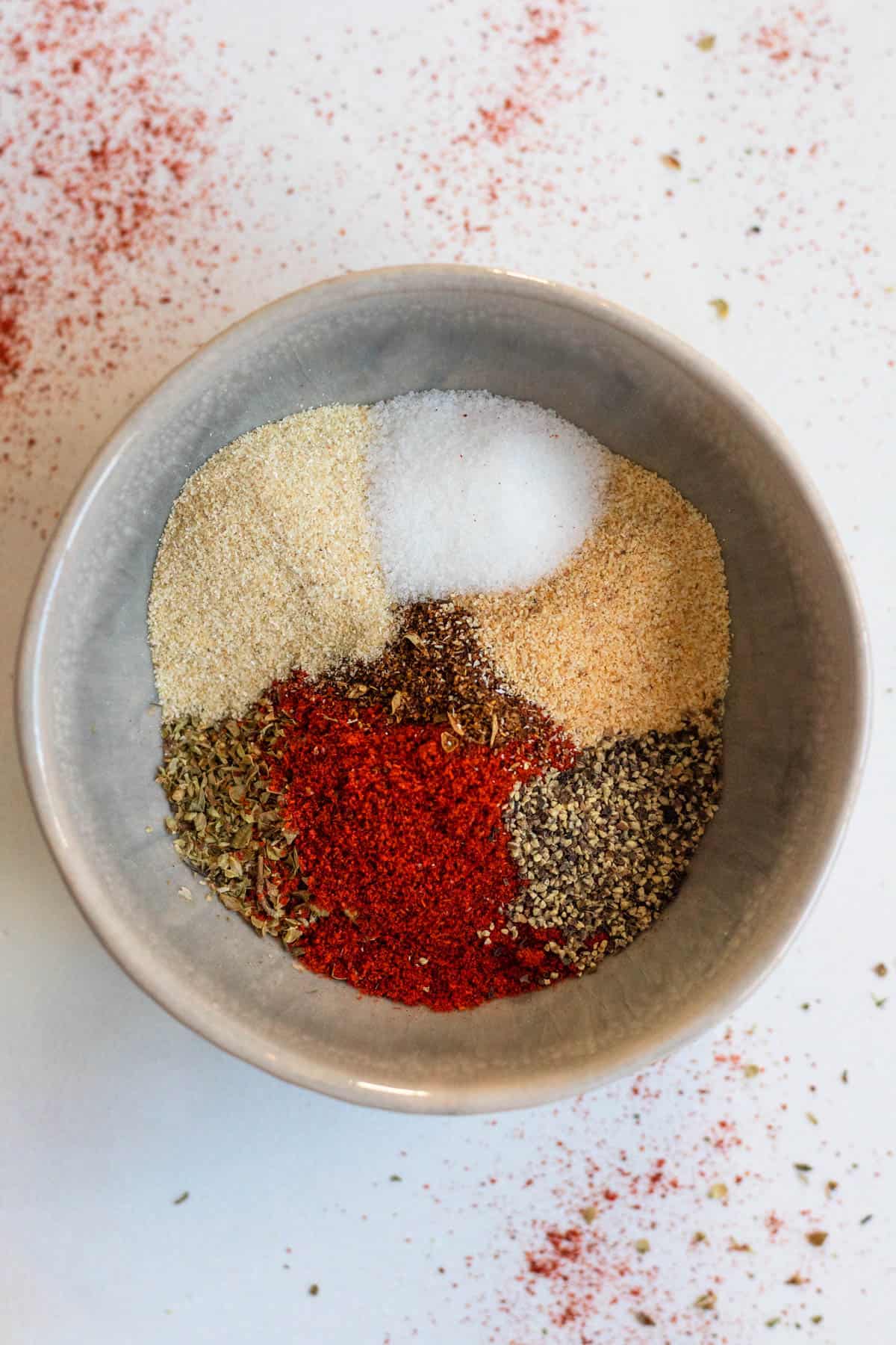 Mexican seasoning blend in a small round bowl with a light colored background
