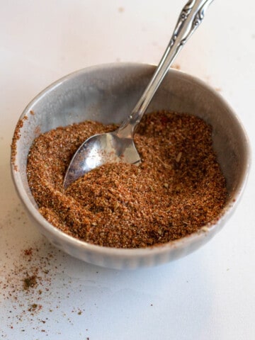 Mexican seasoning in a small round bowl with a light colored background
