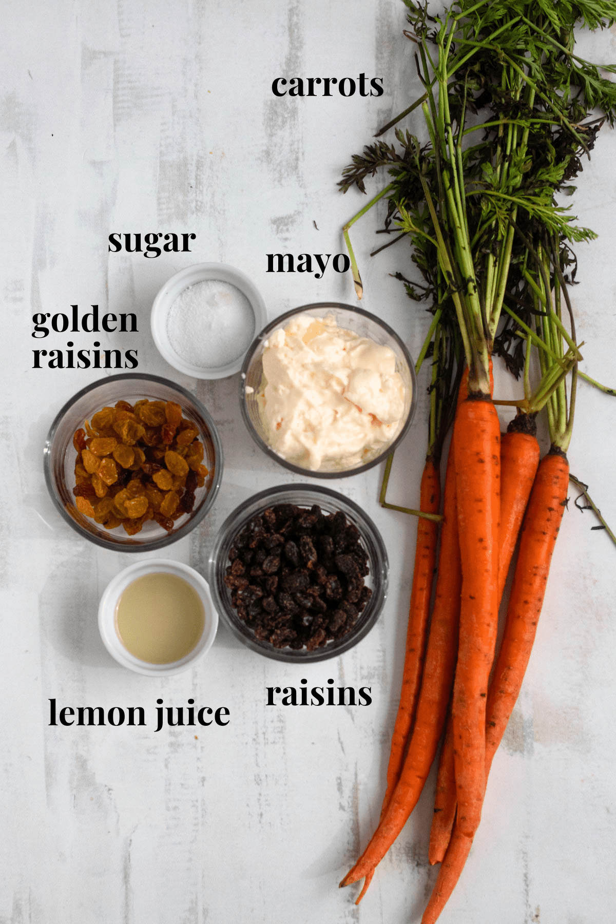 carrot raisin salad ingredients on a light colored background