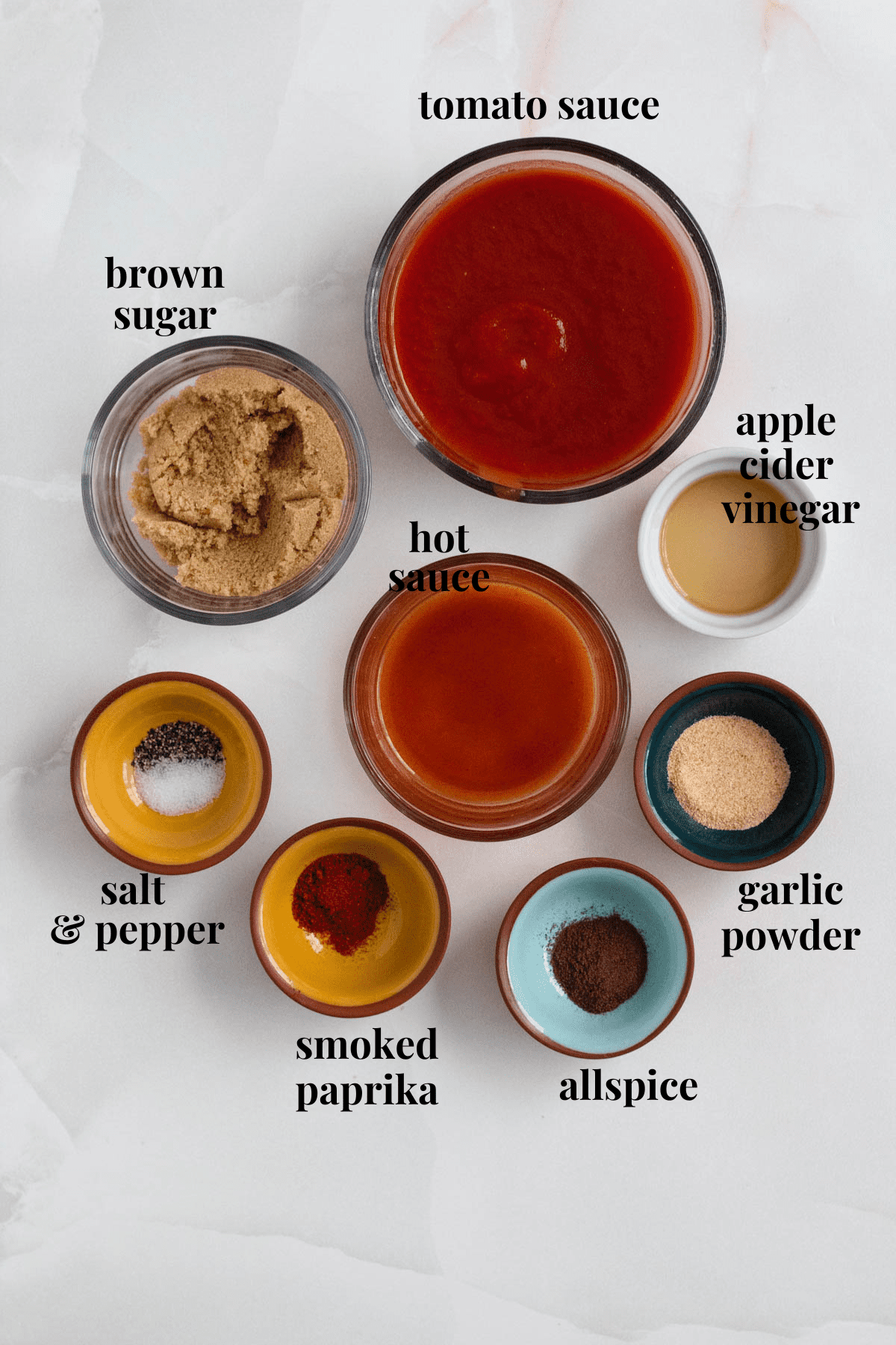 chili sauce ingredients in small bowls with a light colored background